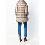 Back view of Herno Coats Dove Grey padded zipped coat, featuring a feather down design, worn with jeans and maroon boots.