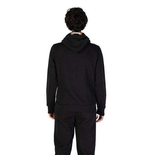 Back view of a man wearing Hydra Clothing Black Cotton Hoody, part of the Fall/Winter collection, made of 60% cotton and 40% polyester.