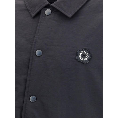 Close-up of Kenzo Black Nylon Bomber jacket featuring metal button closure and Kenzo Boke Flower 2.0 rubber logo on black matte fabric.