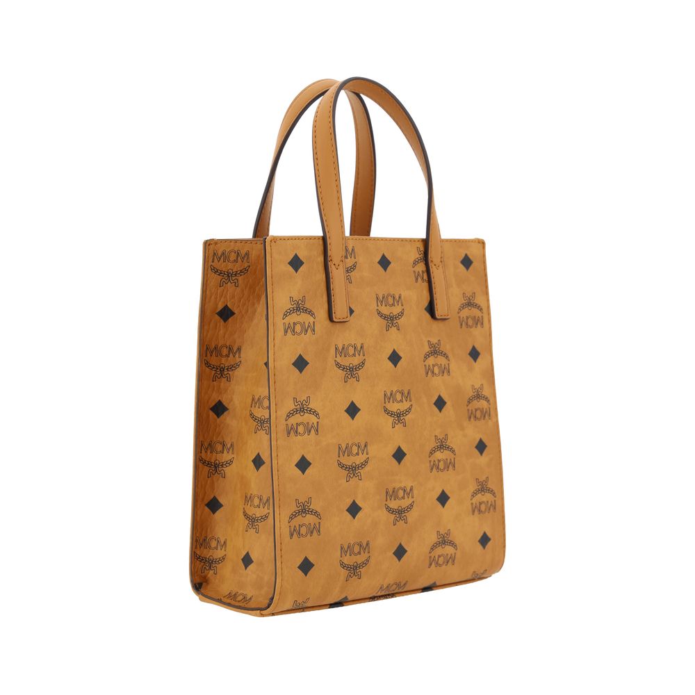 MCM Aren Mini Tote Handbag with iconic brand logo, leather trim, and adjustable shoulder strap, featuring a metal plaque monogram.