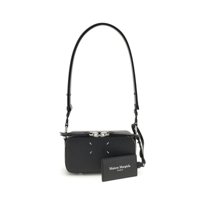 Margiela Black Calf Leather Bos Taurus Shoulder Bag with four-stitch logo and adjustable strap, displayed in front view.