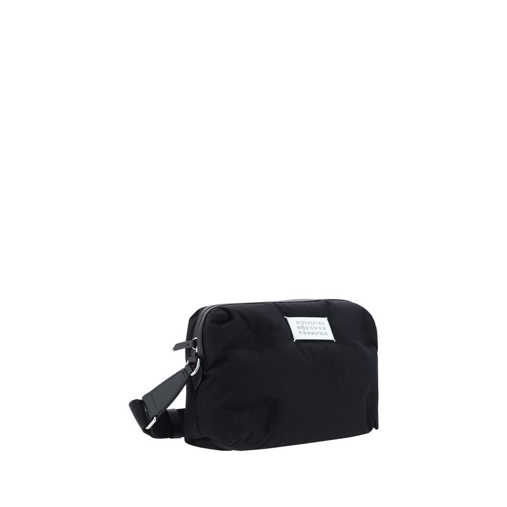 Margiela Black Nylon Shoulder Bag with contrasting logo, zipper closure, and adjustable strap. 100% nylon, 29x29x12cm.