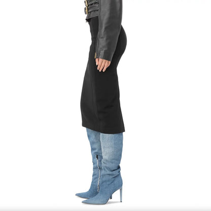 Side view of model wearing PINKO Black Viscose Skirt with rear slit, slim fit, made in Italy, styled with denim boots.