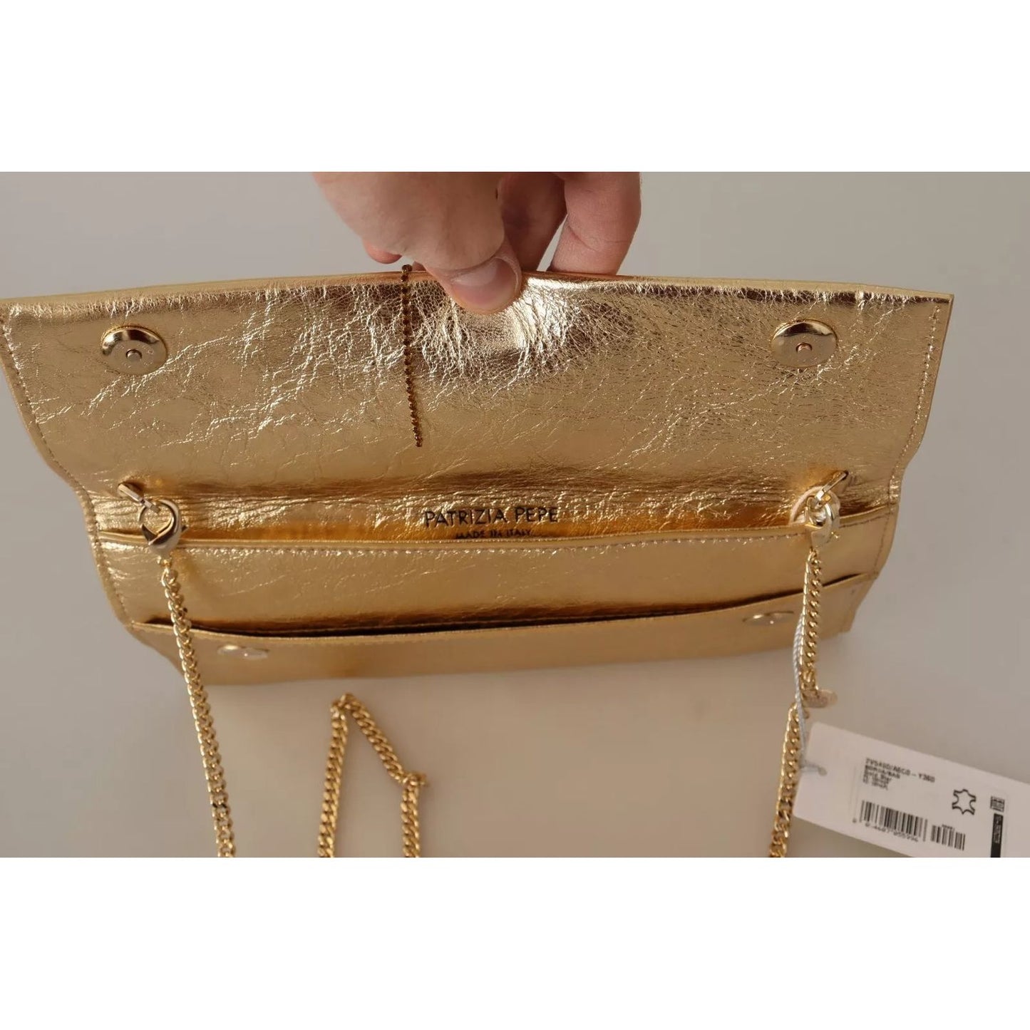 Interior view of Patrizia Pepe Gold Leather Embellished Shoulder Strap Bag with magnetic flap closure and brand tag.