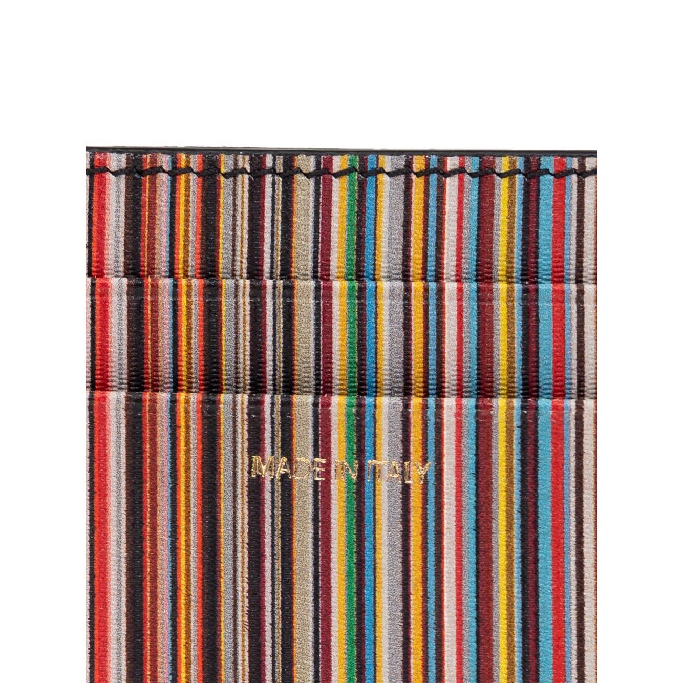 Close-up of Paul Smith Signature Stripe leather card case showing colorful stripes and logo stamp on black leather.