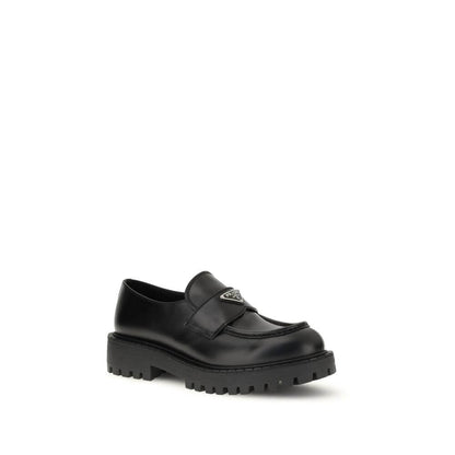 Prada Black Calf Leather Bos Taurus Slip-On Loafers with enameled triangle logo and rubber sole.