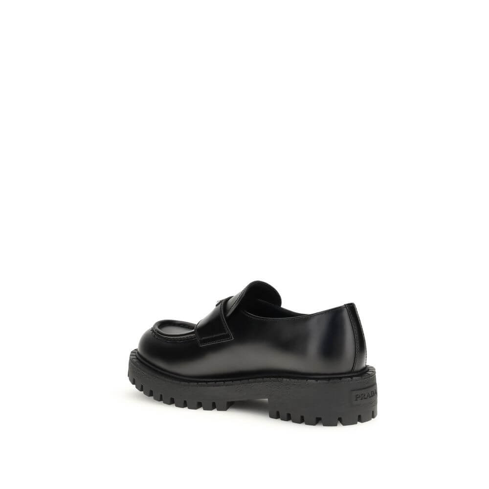 Prada Black Calf Leather Bos Taurus Slip-On Loafers with rubber sole, enameled metal triangle, and stitched tray.