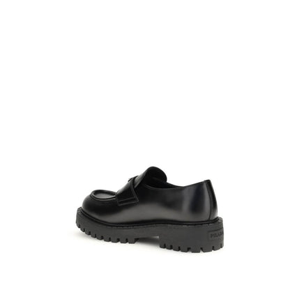 Prada Black Calf Leather Bos Taurus Slip-On Loafers with rubber sole, enameled metal triangle, and stitched tray.