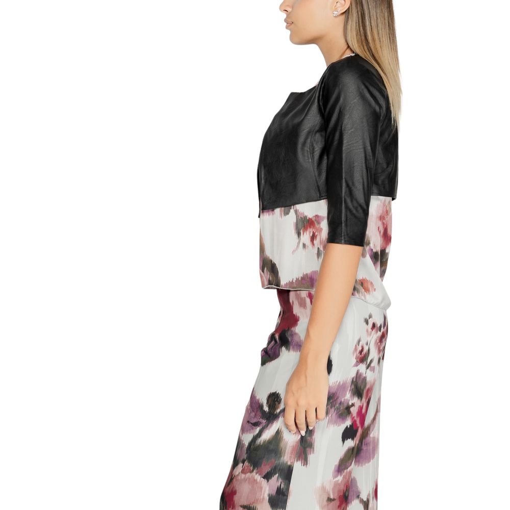 Model wearing Rinascimento Black Polyethylene Cardigan with floral skirt, showcasing short sleeves and elegant design for day and evening.