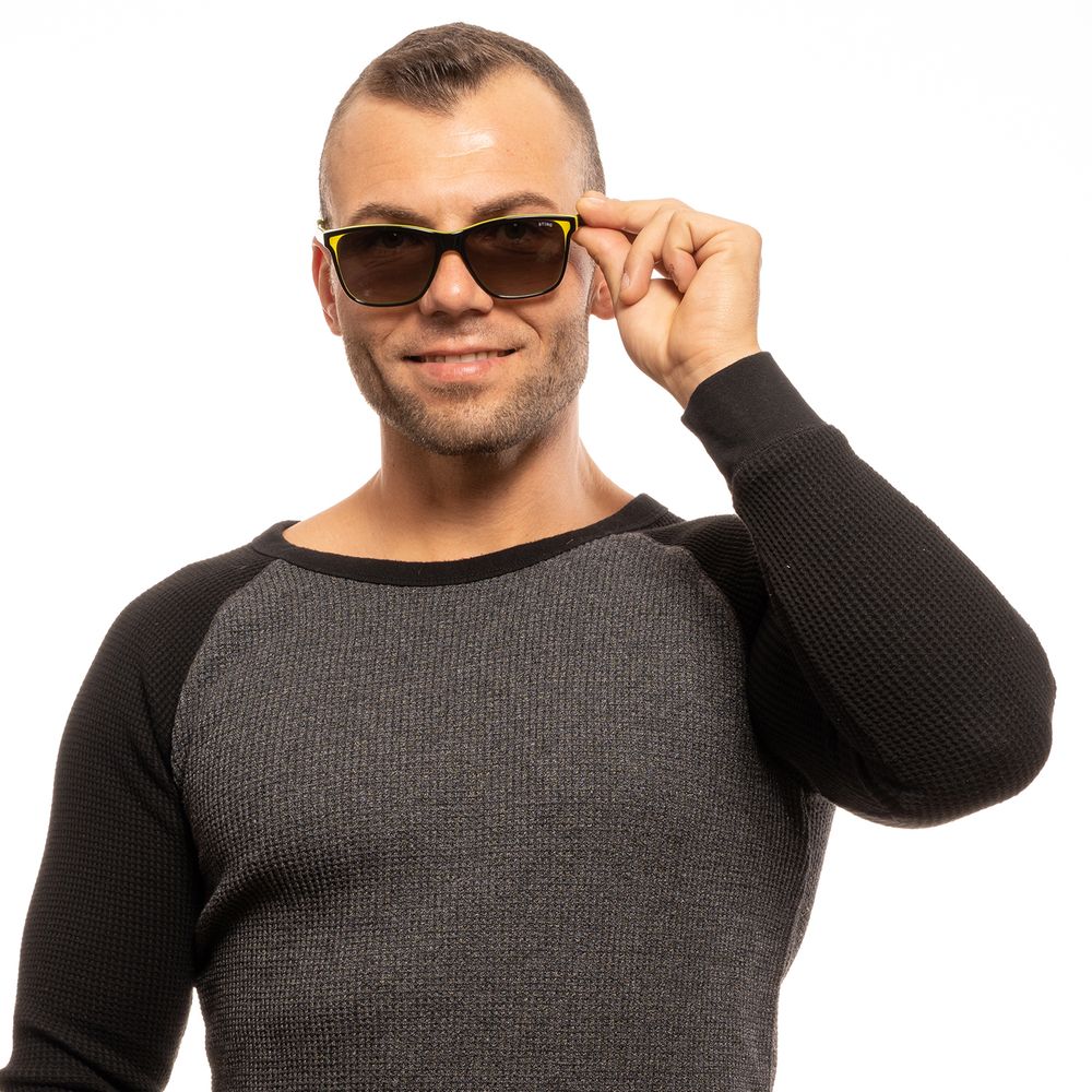 Man wearing Sting Black Men Sunglass with black plastic frame and grey lenses, offering 100% UVA & UVB protection, stylishly posed.