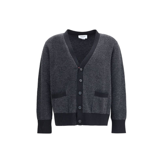 Thom Browne Black Fleece Wool Cardigan featuring V-neck and front button closure with patch pockets, ribbed cuffs, and hem.