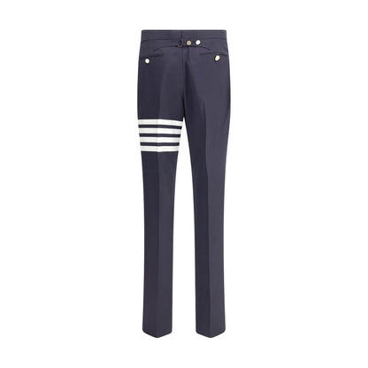 Thom Browne Blue Wool Dress Pants with contrasting buttons and iconic left leg bands, showcasing refined elegance for formal wear.