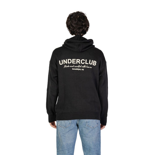 Man wearing the Underclub Black Cotton Sweater with hood and ribbed cuffs, displaying back view, text "Brooklyn, NY" visible.