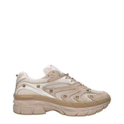 Valentino Garavani Beige Fabric Low Top Sneakers with front and back logos, studs, lace-up closure, rubber sole, round toe and mid heels.
