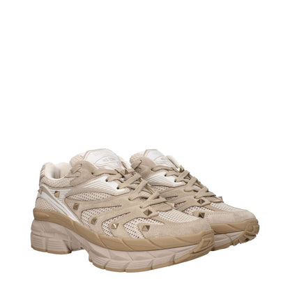 Valentino Garavani Beige Fabric Low Top Sneakers with logo and studs, lace-up closure, rubber sole, and mid heels.