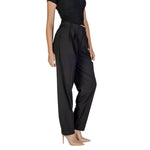 Woman wearing Vila Clothes Black Polyester Pant with high waist and front pleats, styled elegantly with heels.