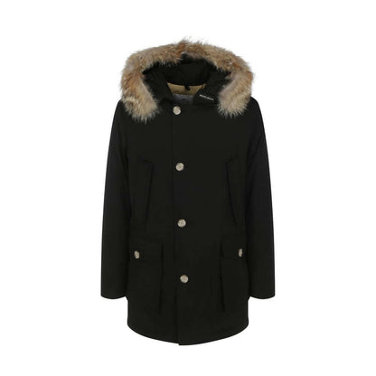 Woolrich Black Cotton Parka with fur hood, featuring side patch pockets, ribbed cuffs, and padded design for AW25 season.
