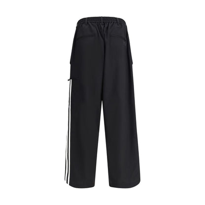 Y-3 Black Wool Casual Pants with elastic waistband and asymmetrical cuffs, featuring side stripes and back pockets.