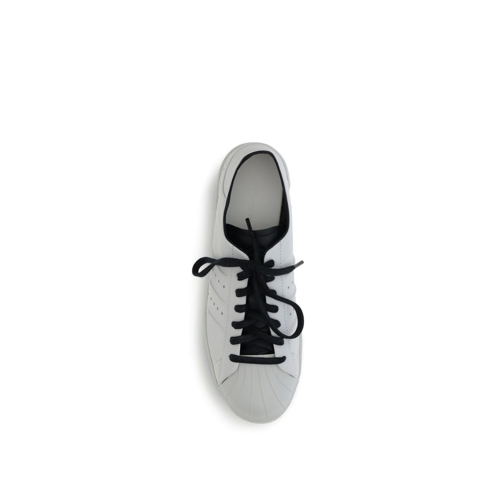 Y-3 White Calf Leather Bos Taurus Low Top Sneakers with rubber clamshell toe and black laces, top view.