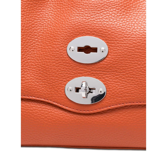 Close-up of Zanellato Postina Daily Small leather handbag in orange with twist-lock fastening details.