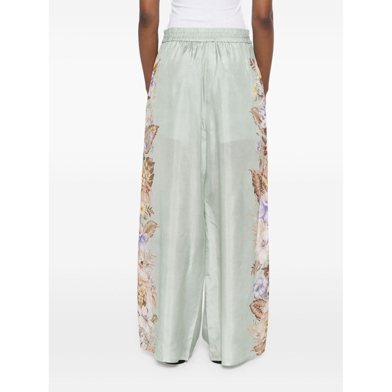 Zimmermann Coco trousers in sage green with floral print and elasticated waistband, side pockets, back view.